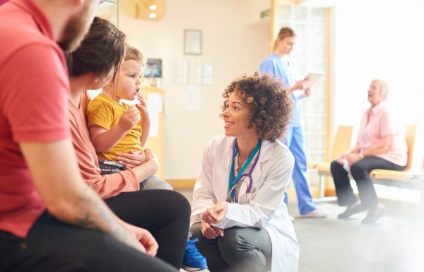 Toddler talking to female doctor