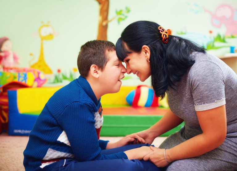 Son and mother touching foreheads