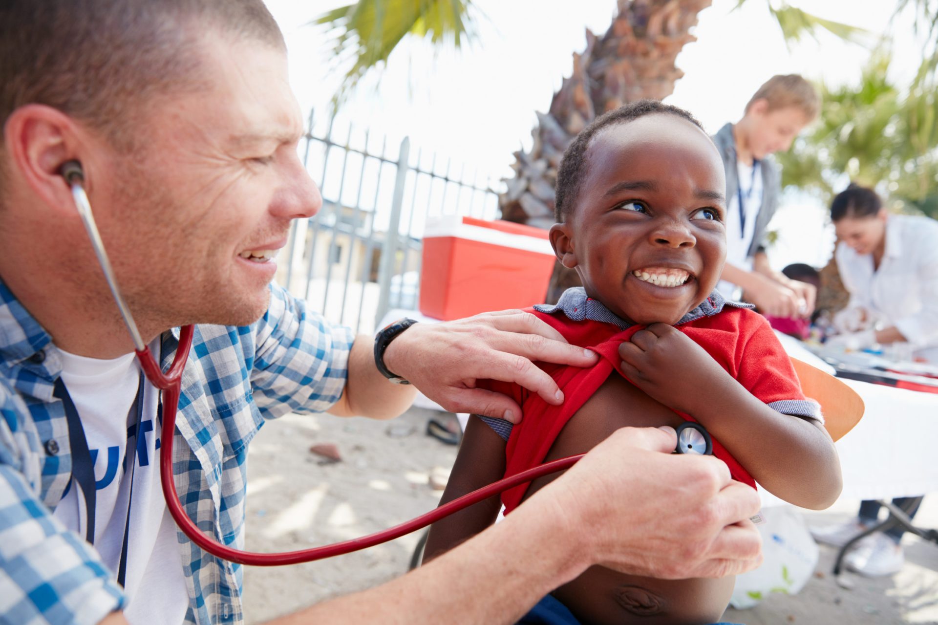 Shot of a volunteer doctor giving checkups to underprivileged kids