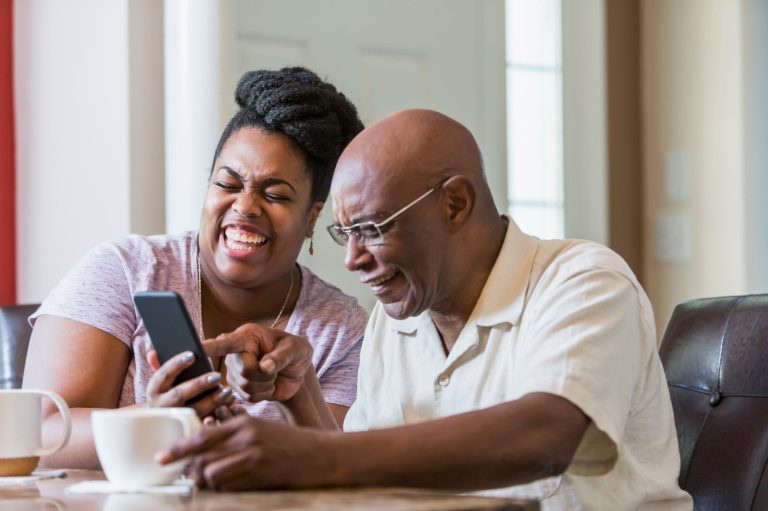 Father with daughter using smart phone