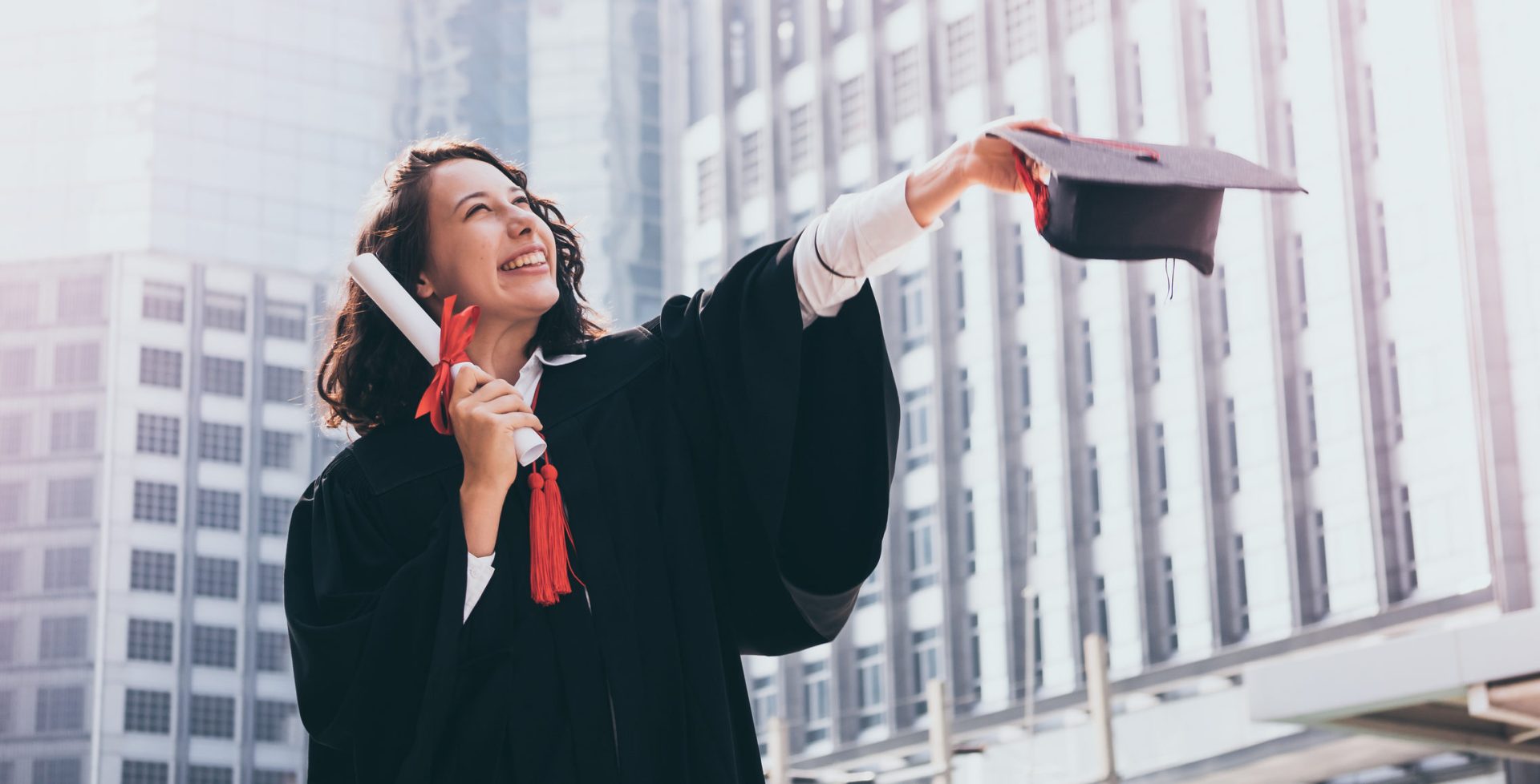 Graduation day, Young woman with graduation cap and gown holding diploma, Successful concept