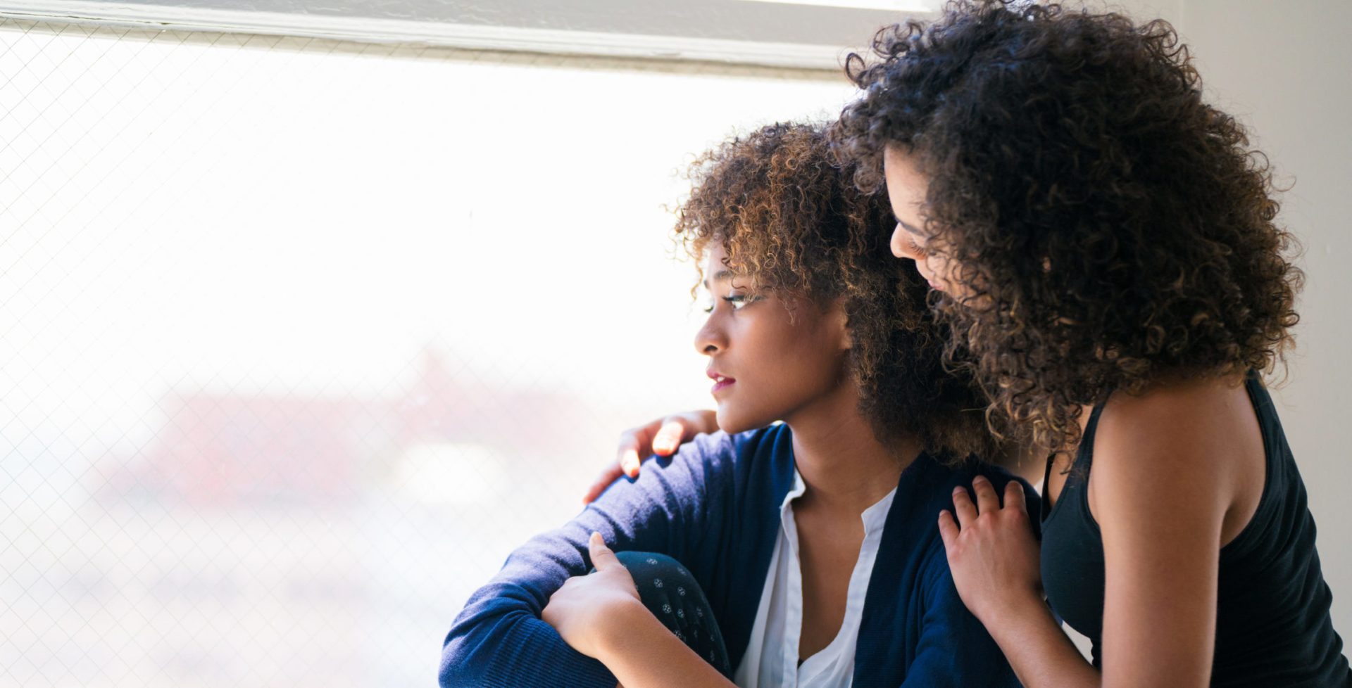 Young woman consoling her friend