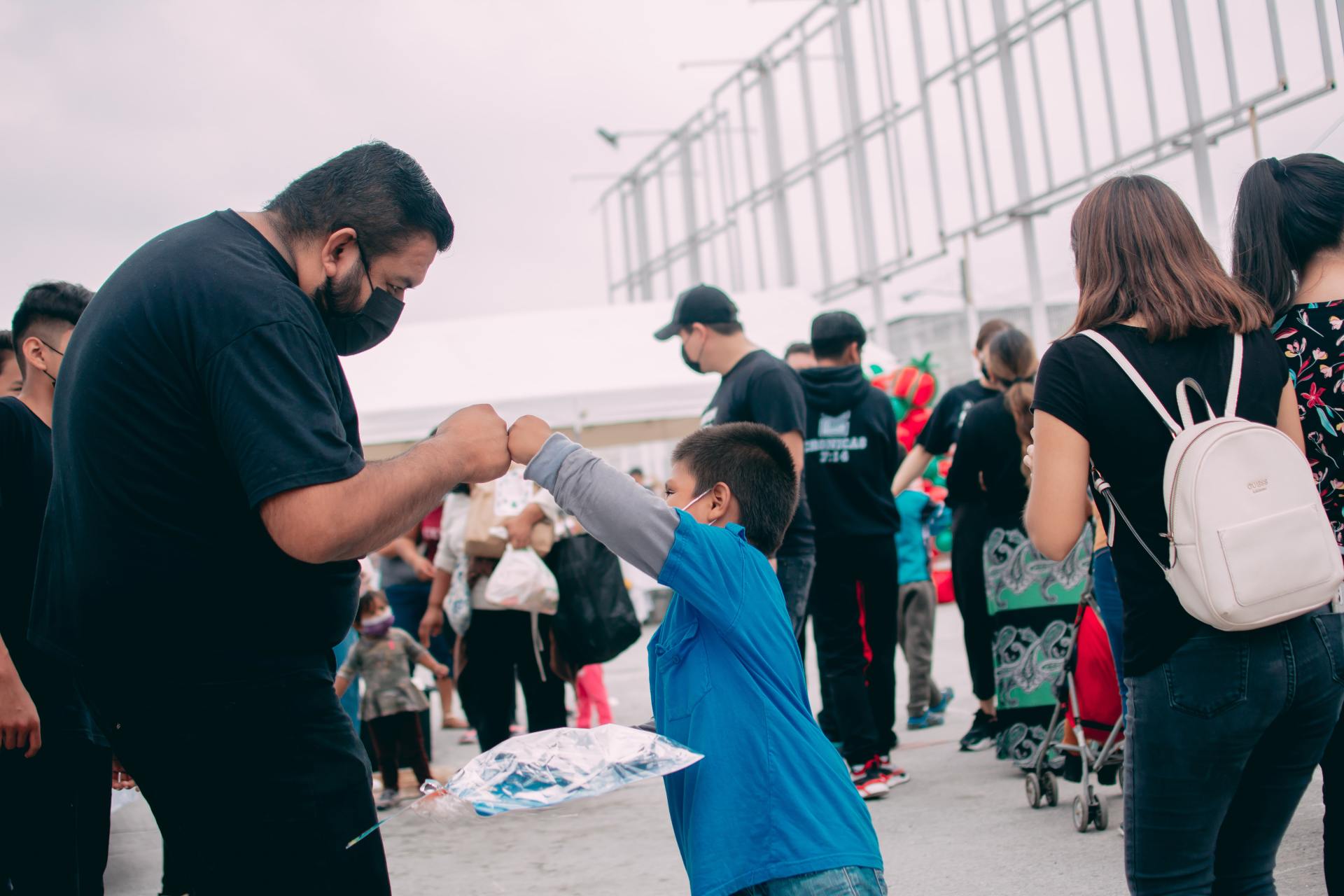 Adult and child fist bumping each other