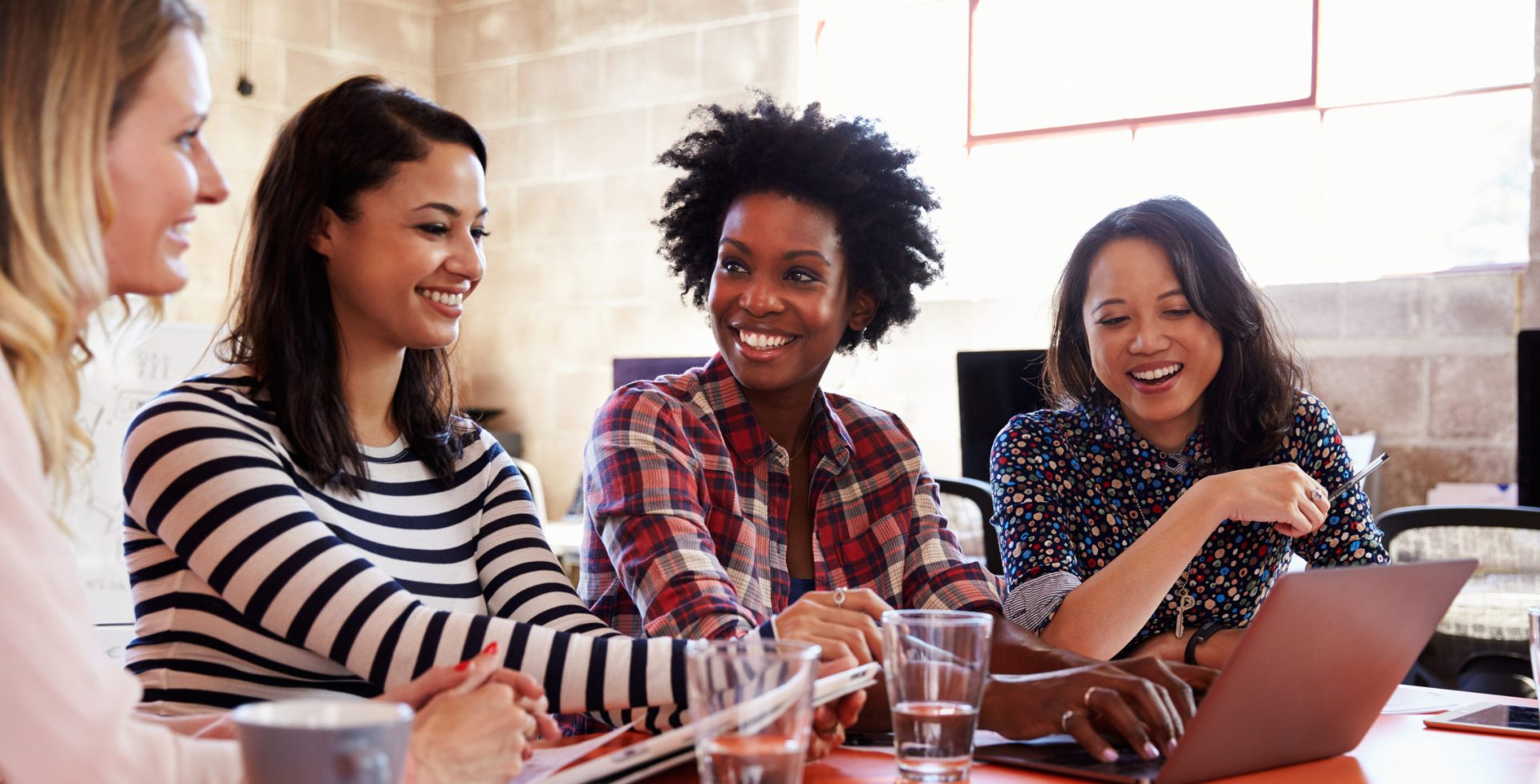 Group Of Female Designers Having Meeting In Modern Office