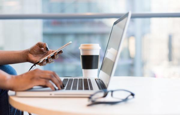 A person on a laptop and phone