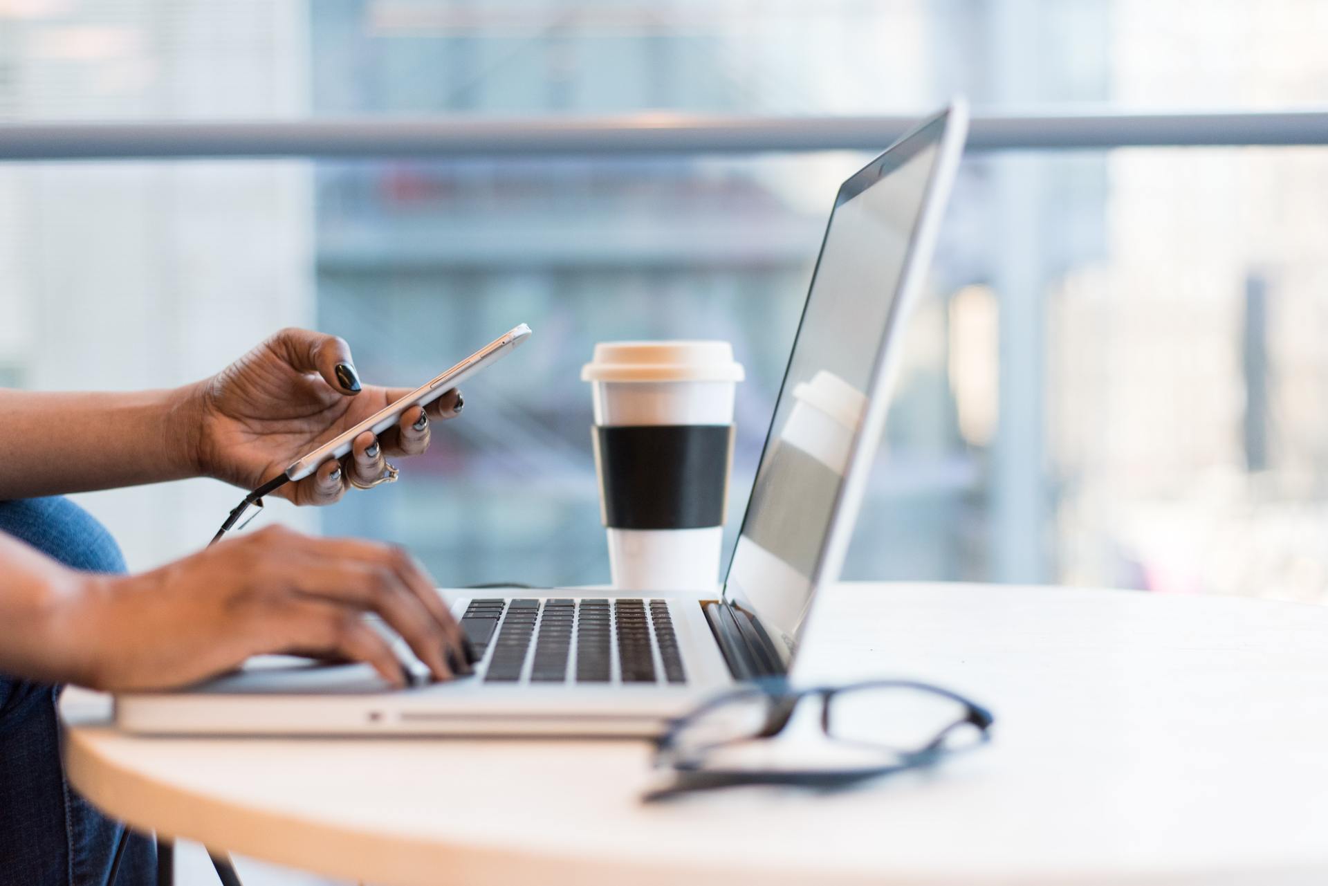 A person on a laptop and phone