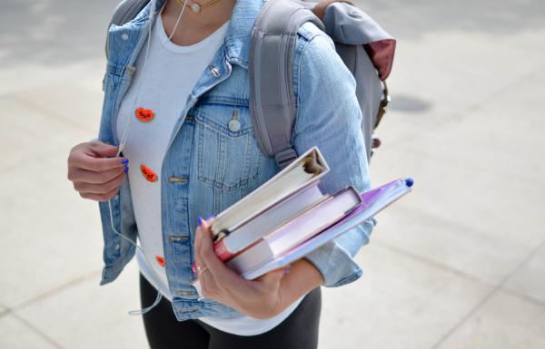 A person holding school books