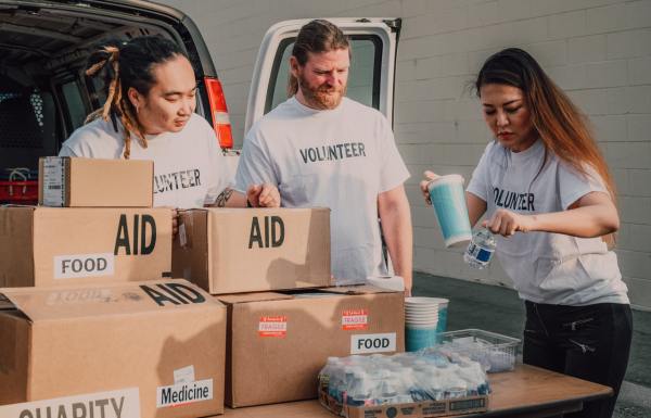 Volunteers setting up a table with boxes of aid