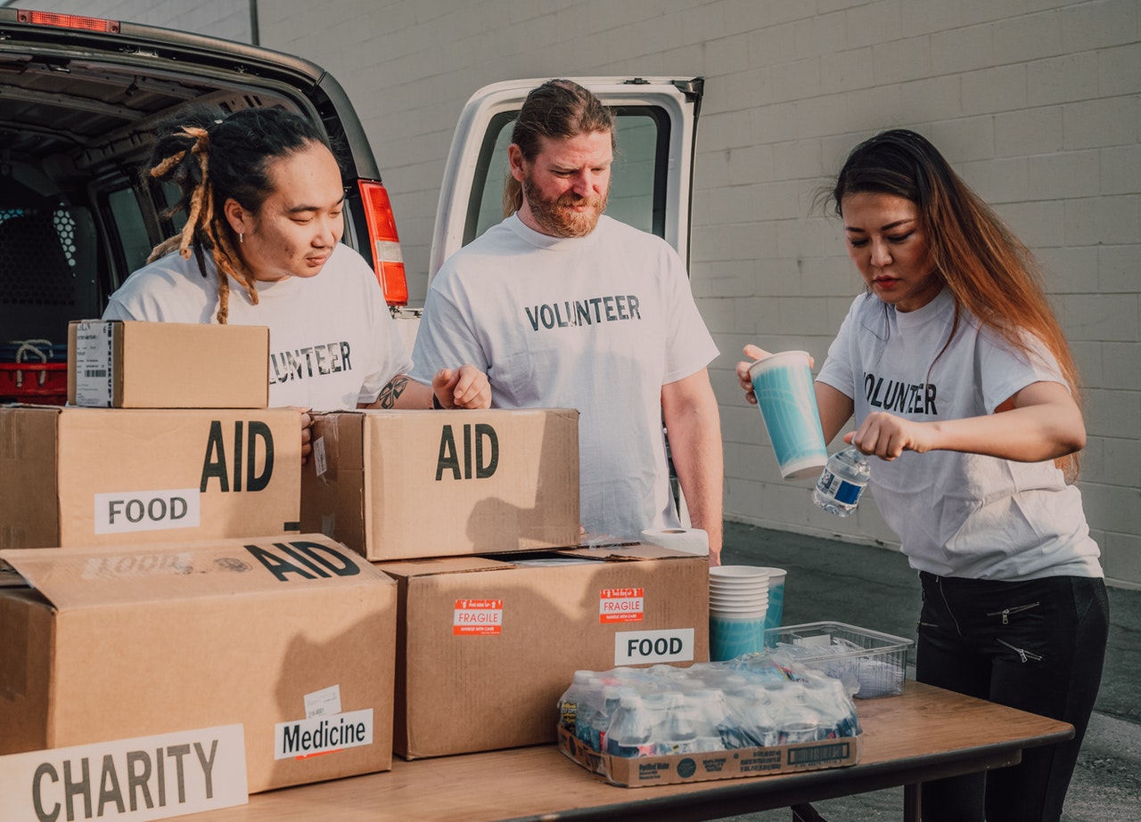 Volunteers setting up a table with boxes of aid