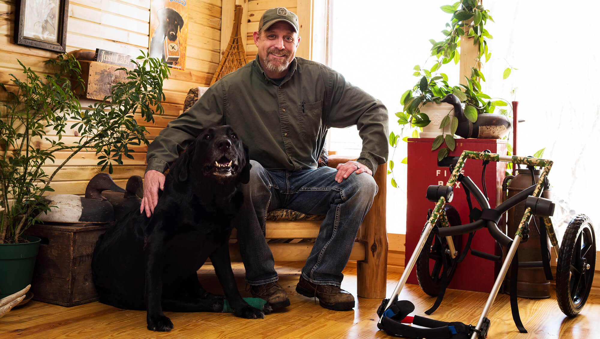 man with his dog smiling for the camera in their home