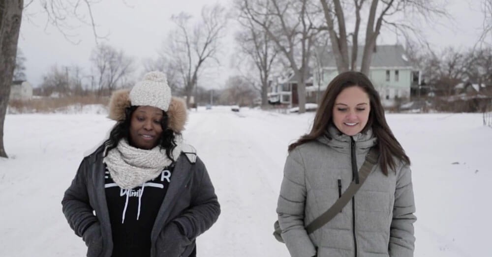 Two women walking in the snow