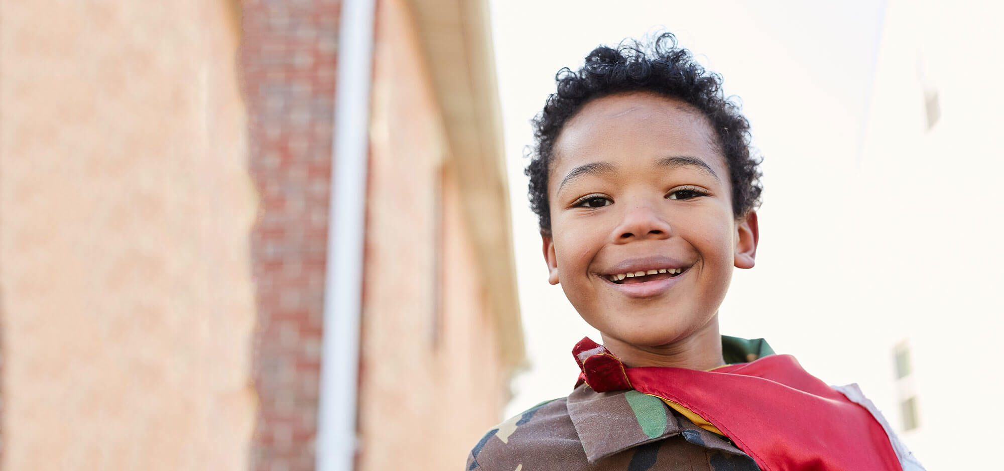 Little boy in cape smiling