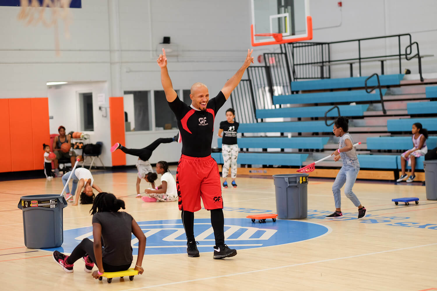 Man celebrating and children playing games in the background