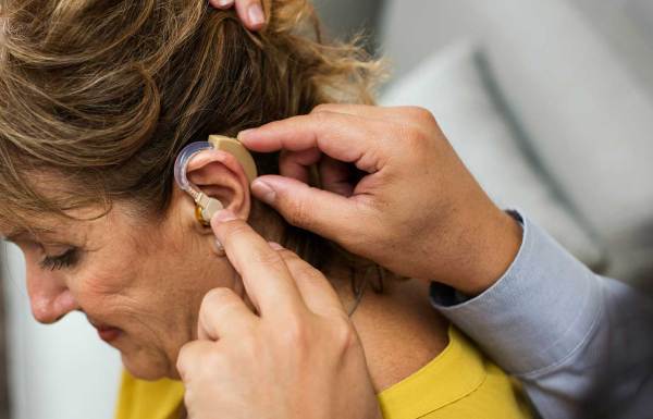 A woman getting fitted for hearing aids