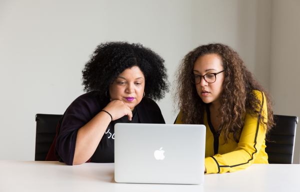 Two people looking at a laptop together