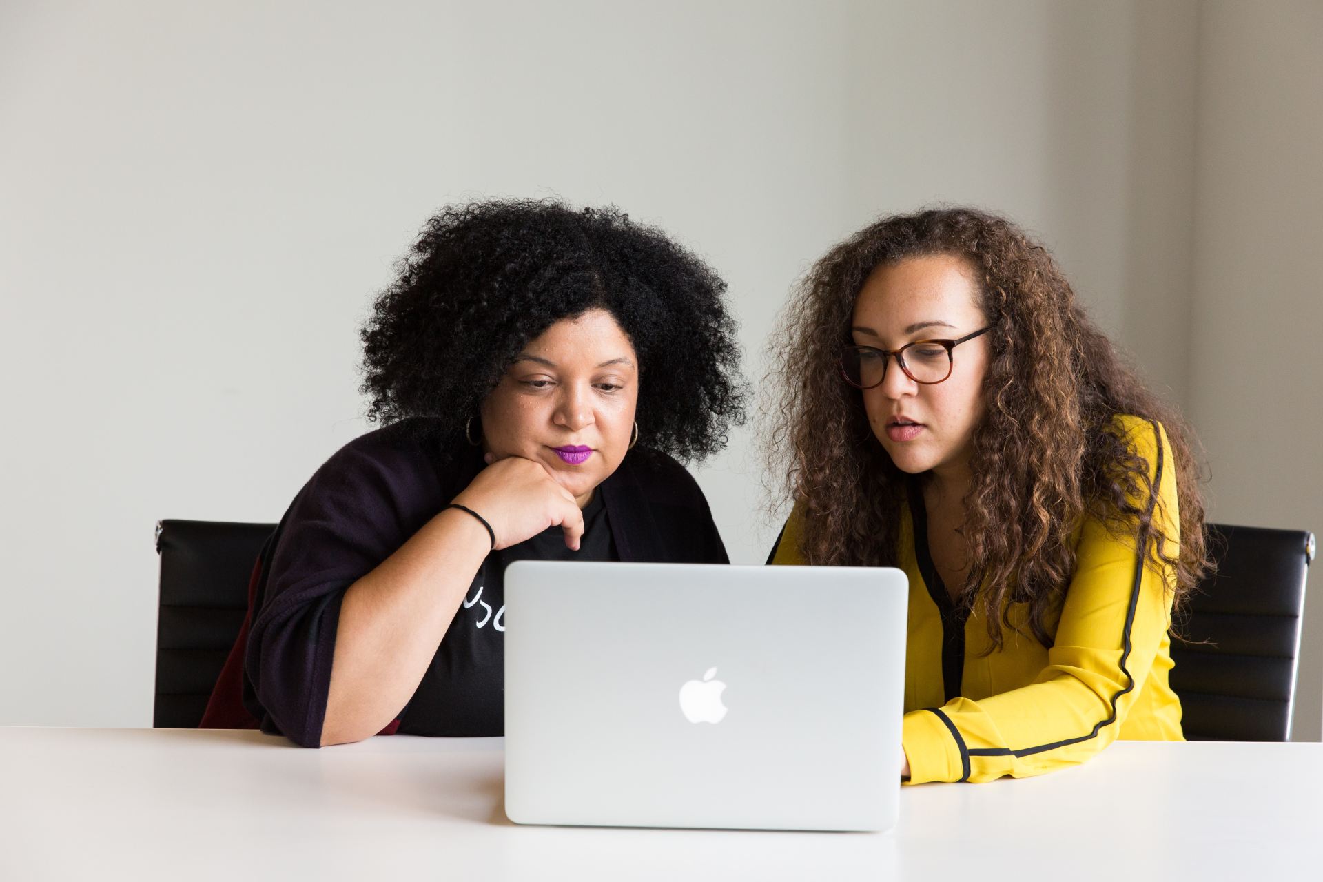 Two people looking at a laptop together