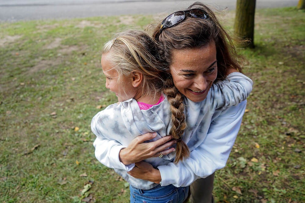 woman hugging a child