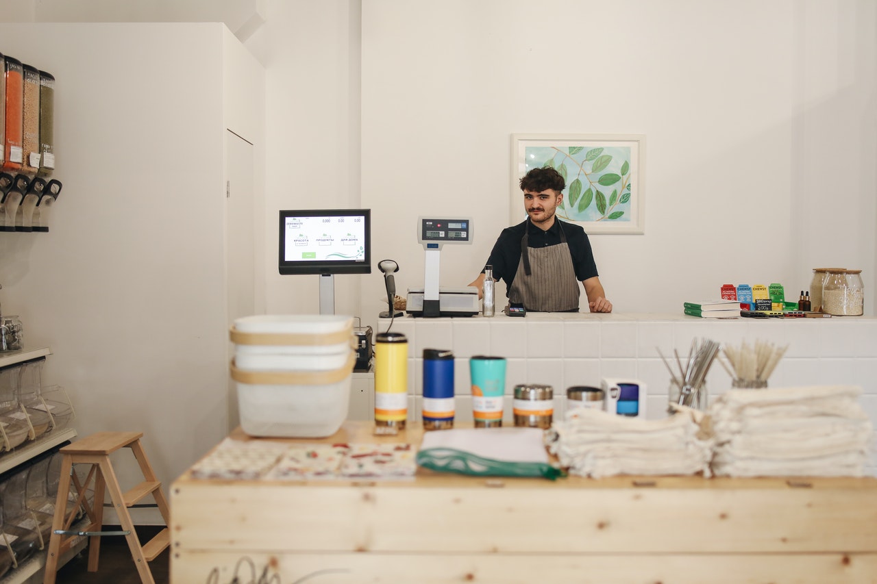 Man behind the counter at a small business