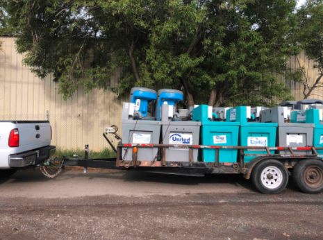 truck pulling portable sanitation stations on a trailer