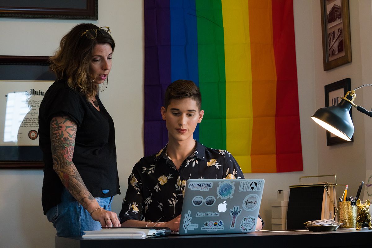 Young man and woman looking at a laptop