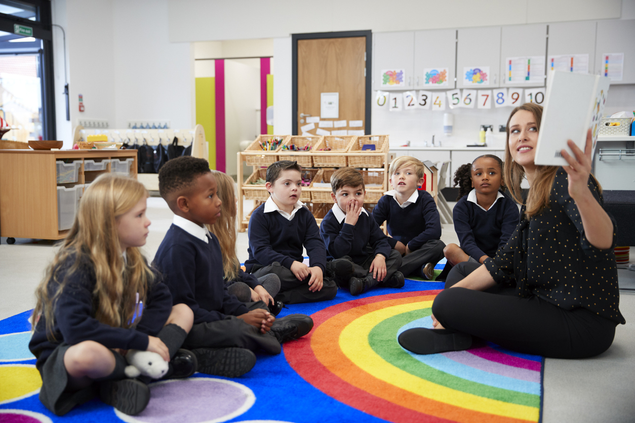 A group of private school students learning from teacher