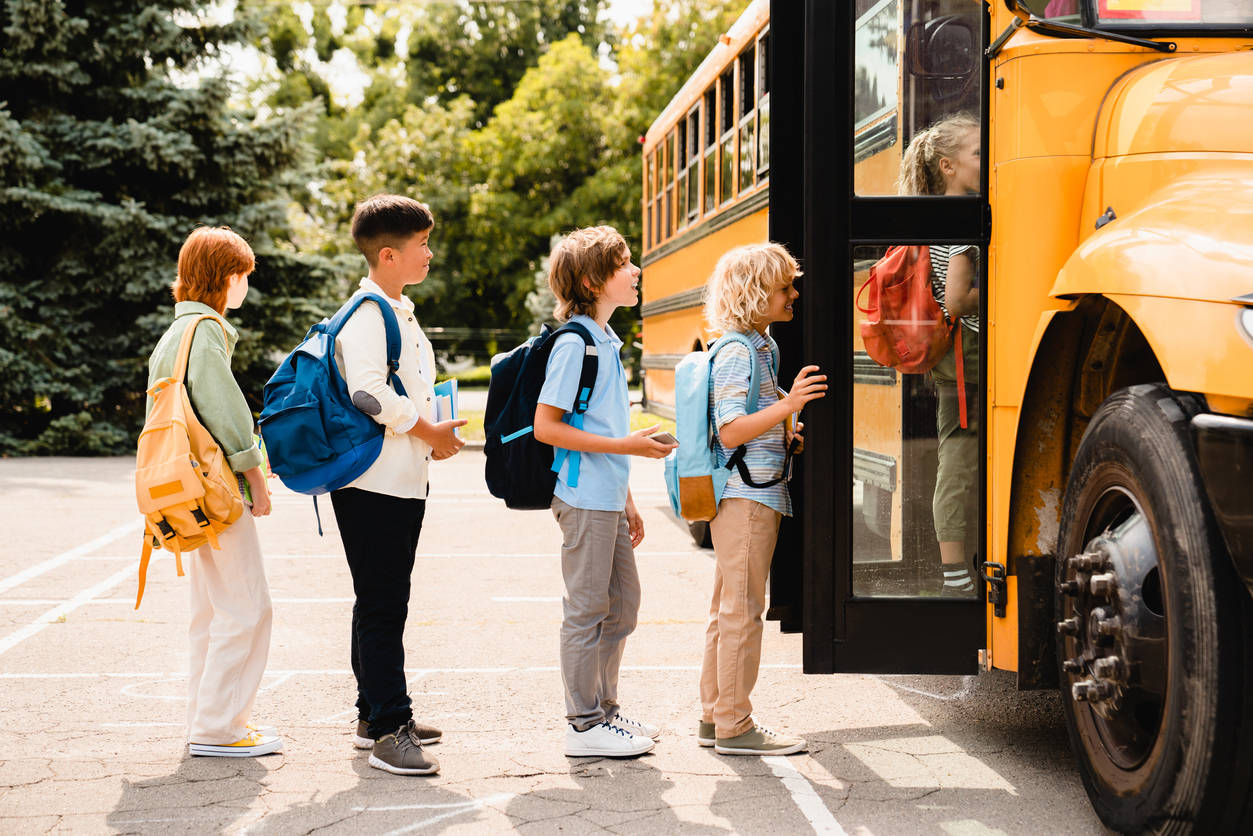 Elementary school kids boarding a bus