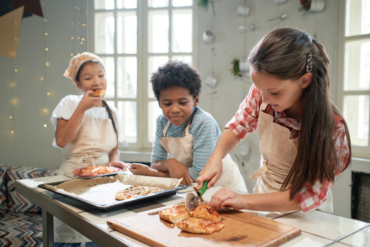 Three children baking.