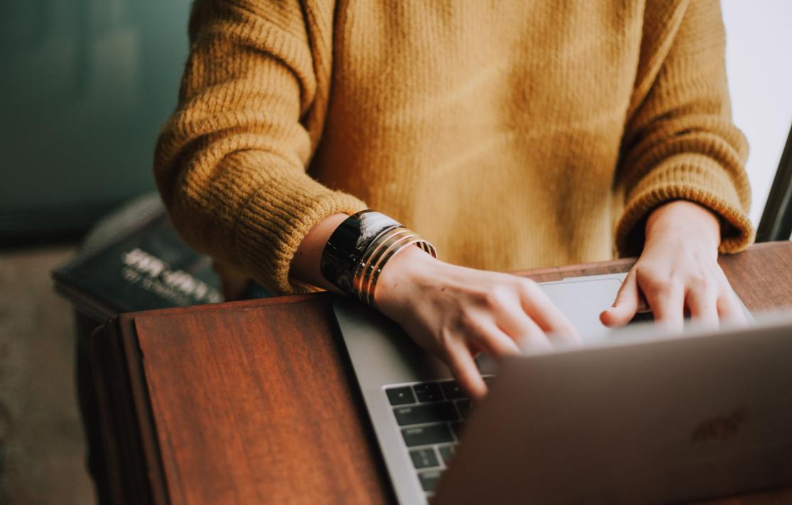A person typing on a laptop