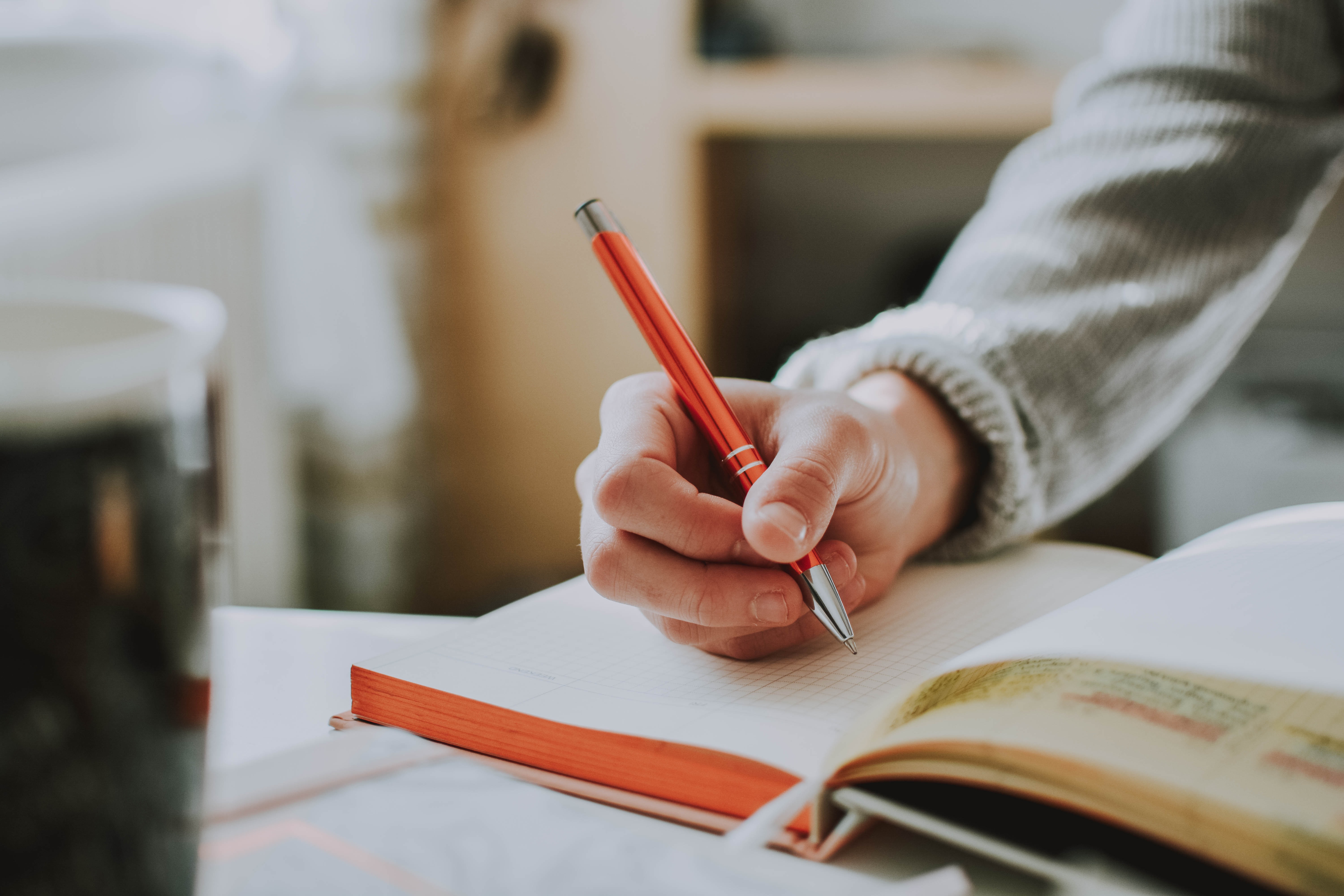 A person writing in a notebook