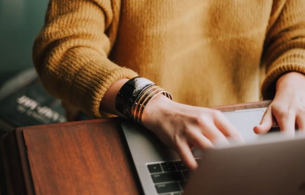Woman typing on a laptop
