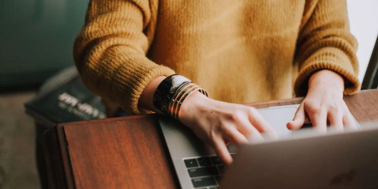 Woman typing on a laptop