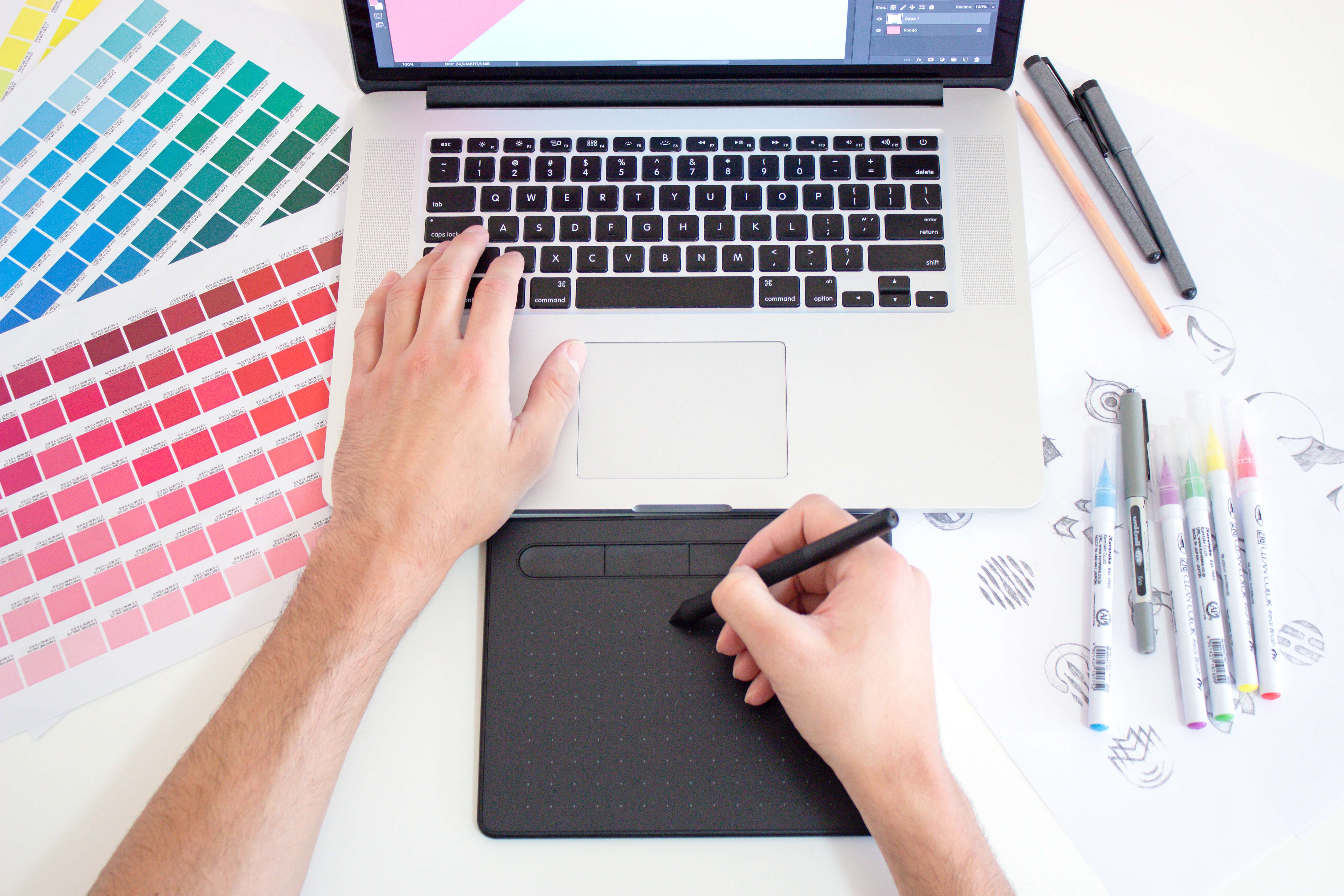 A person doing graphic design on their laptop