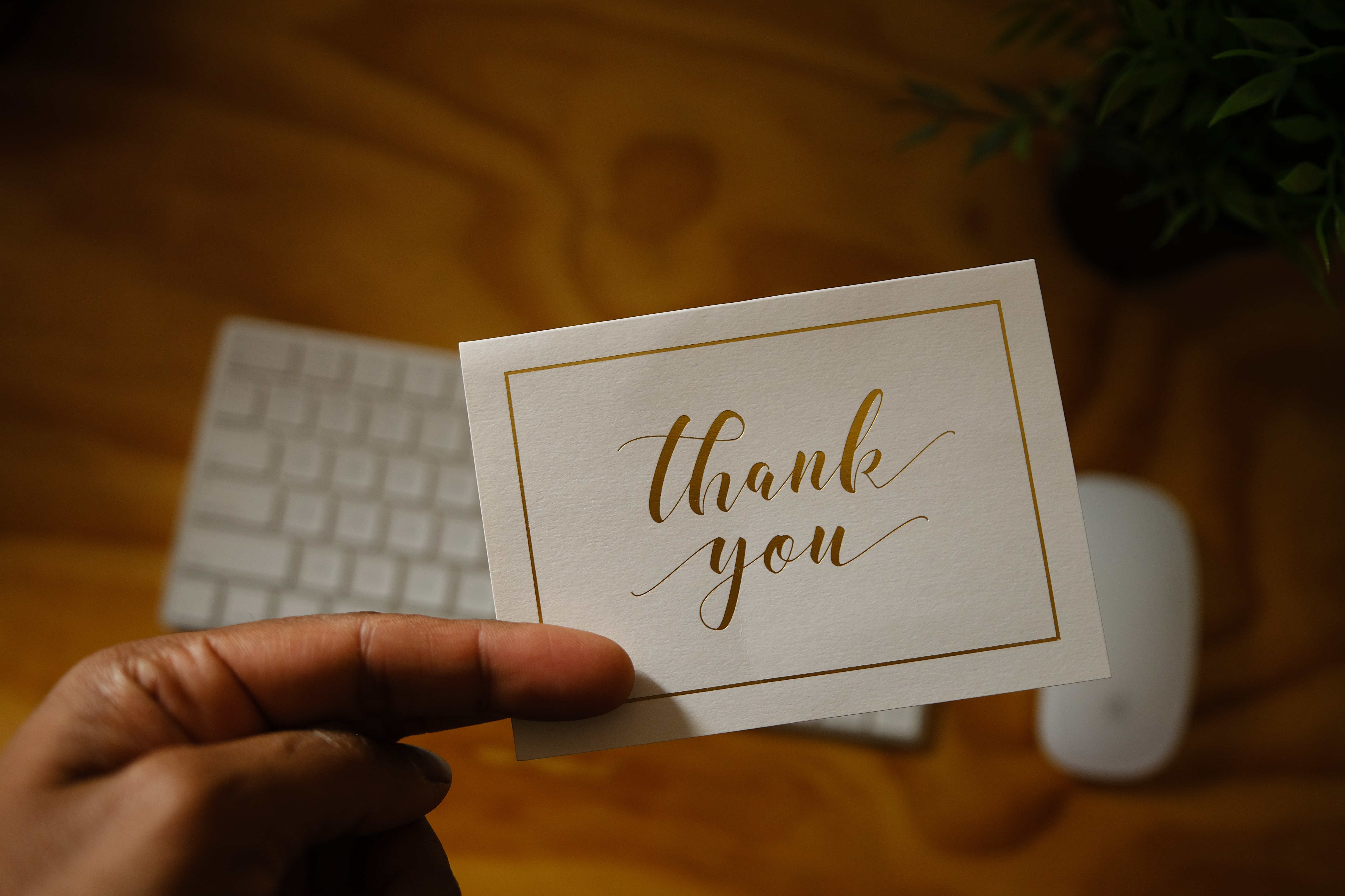 Person holding a thank you card