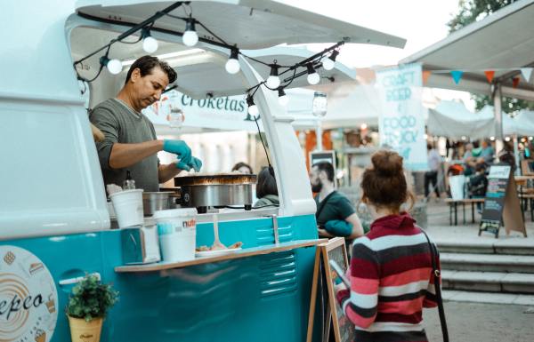 A man in a food truck makes food