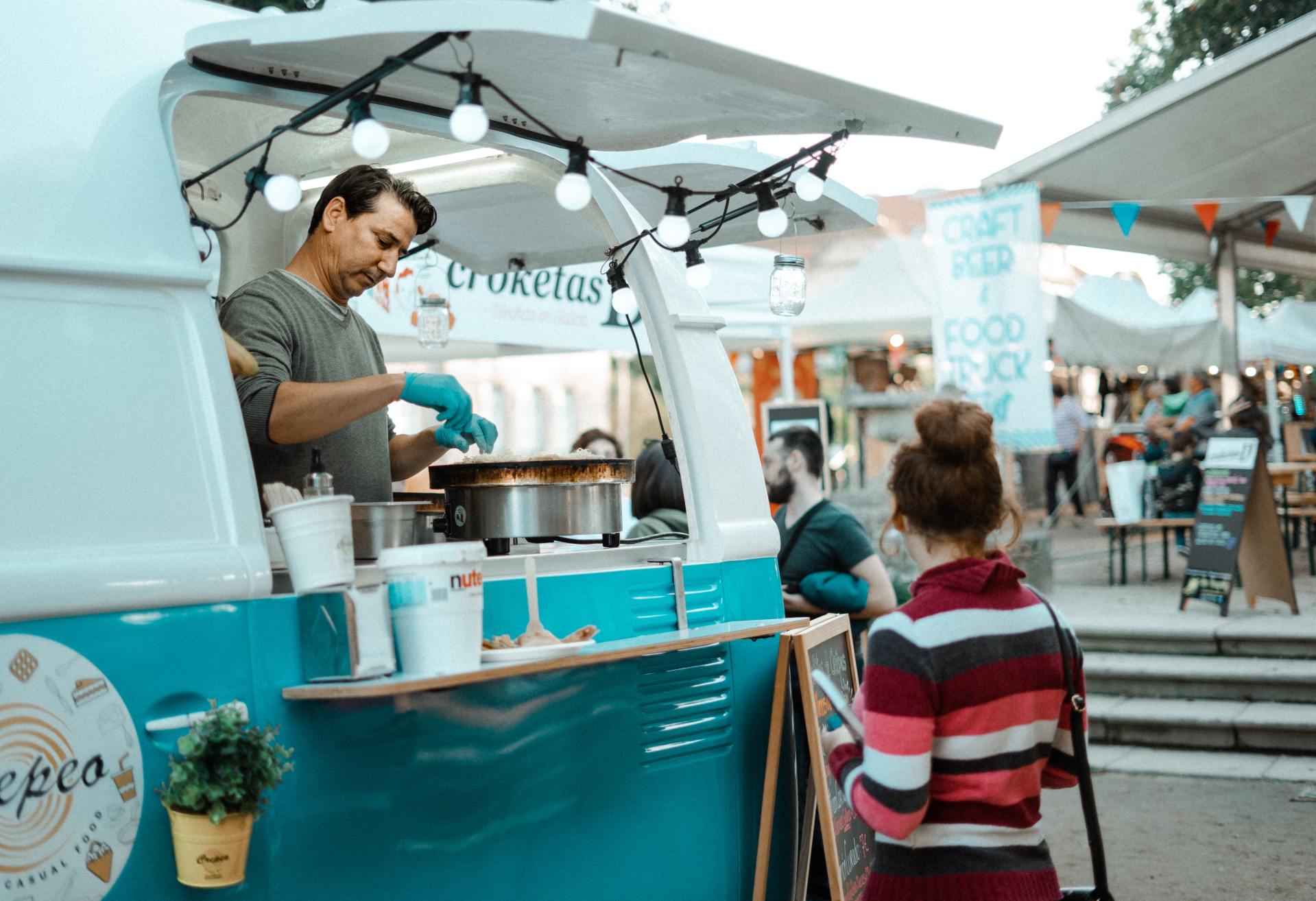 A man in a food truck makes food