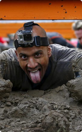 man crawling through mud