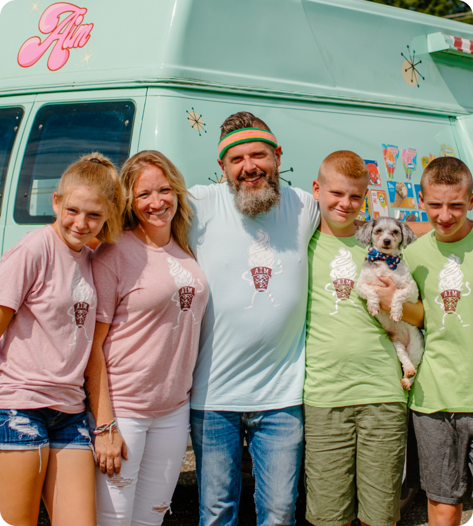 The Watsons family in front of ice cream truck with their dog