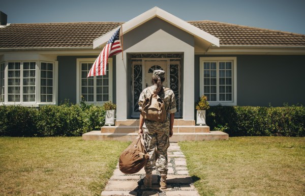 female veteran in front of her home