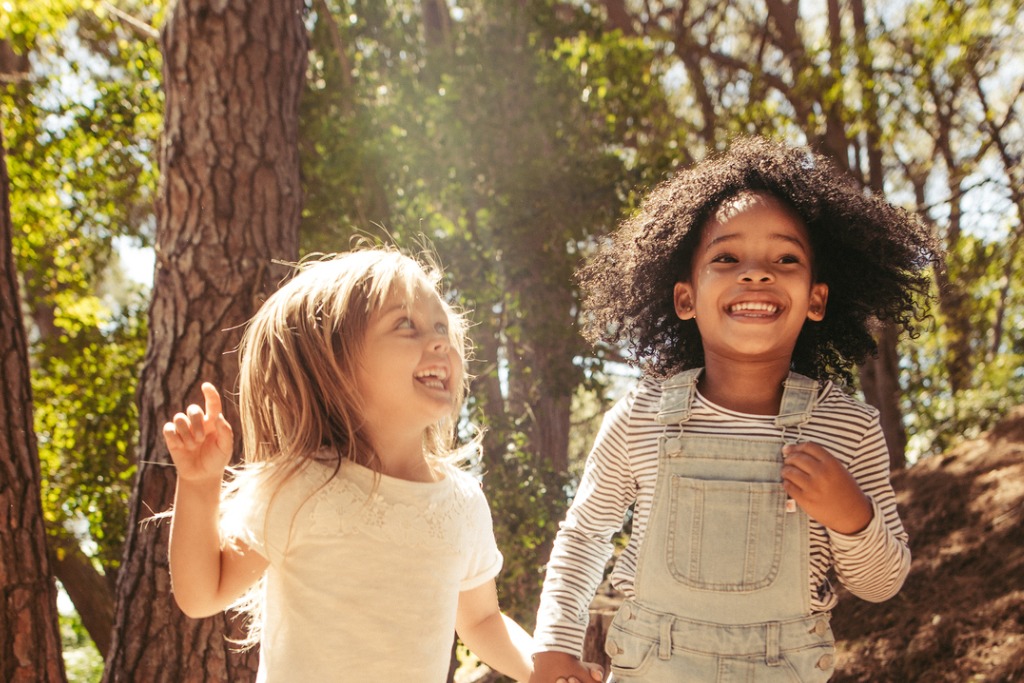 two young girls playing together outside