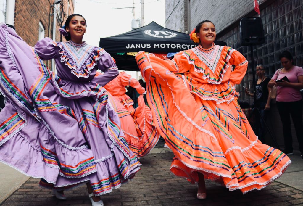 Dancers in colorful dresses honoring Hispanic heritage