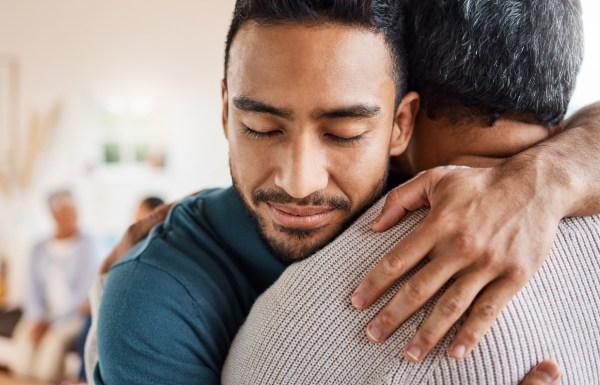 Father and son hugging at home