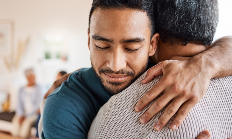Father and son hugging at home