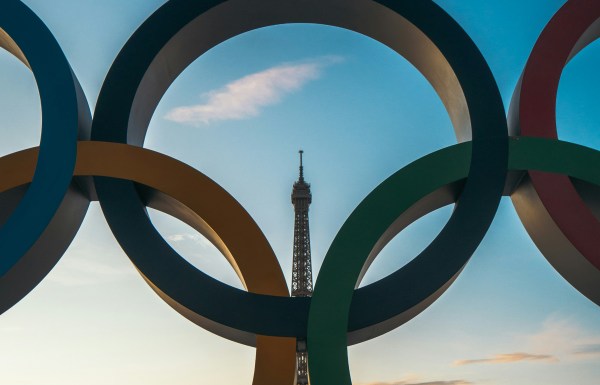 Olympic rings with the Eiffel Tower in the distance