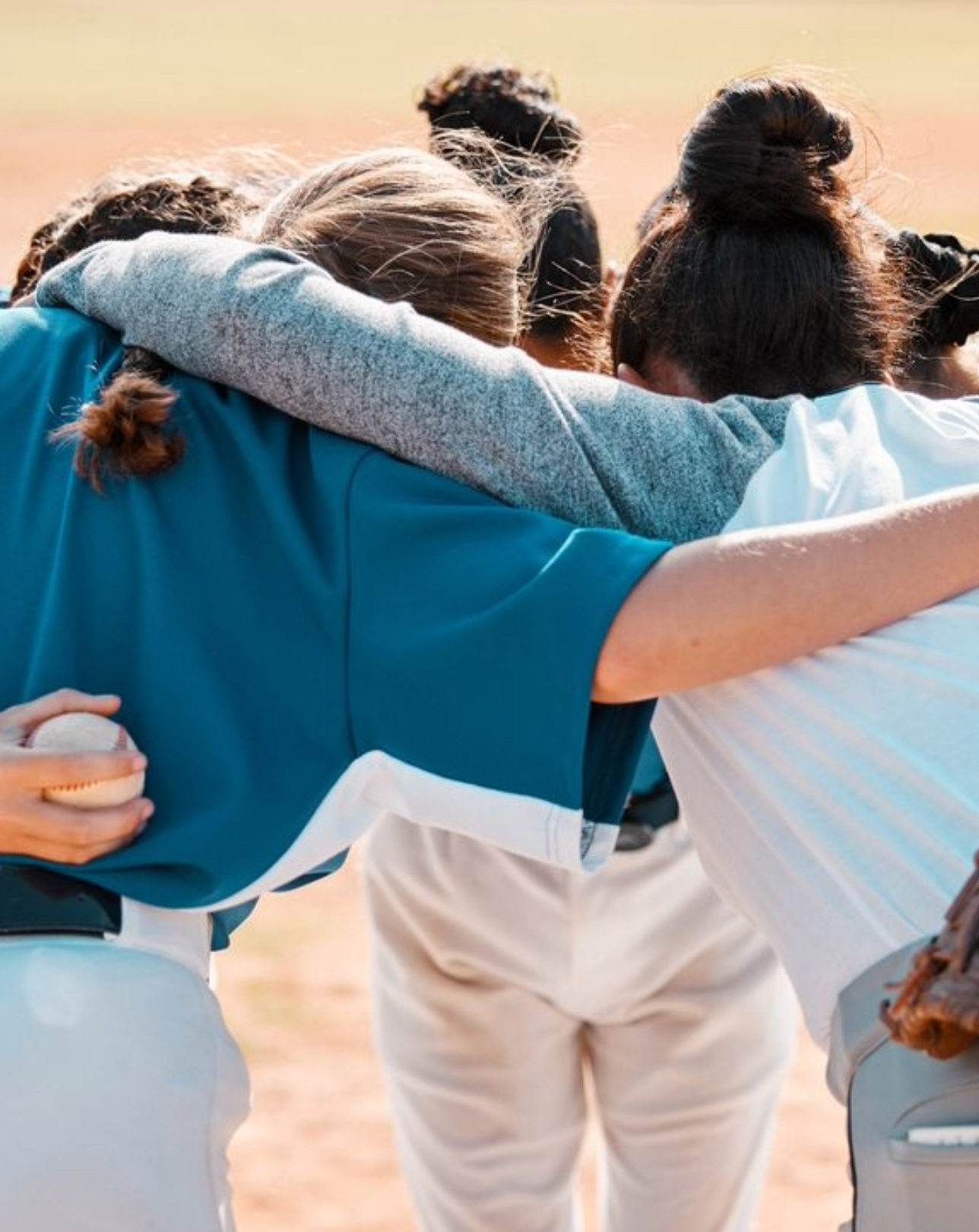 Softball team in a huddle