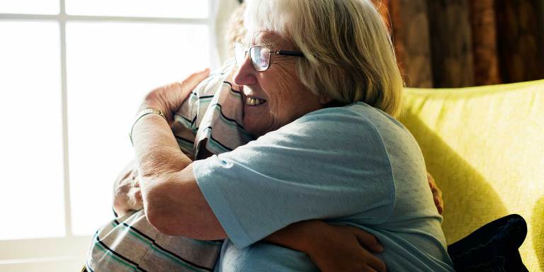 A grandmother being comforted by her grandson
