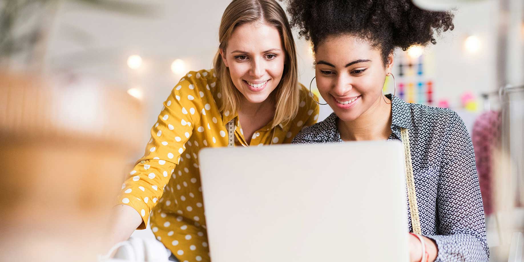 Two friends using a laptop to create a fundraiser