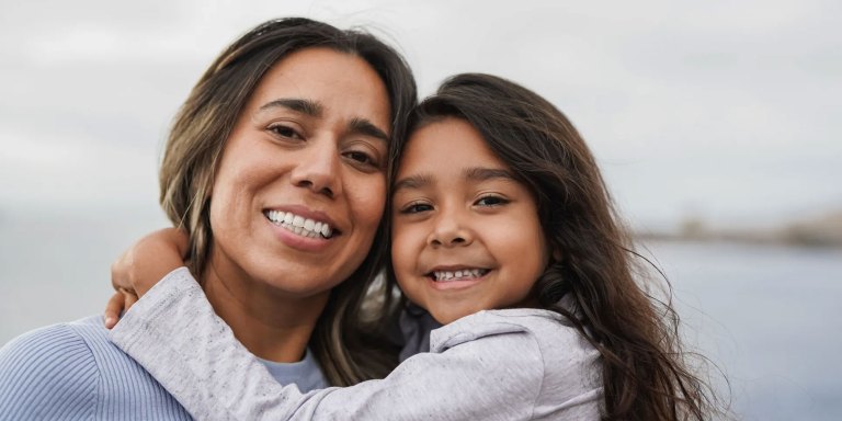 A mother and her daughter smiling
