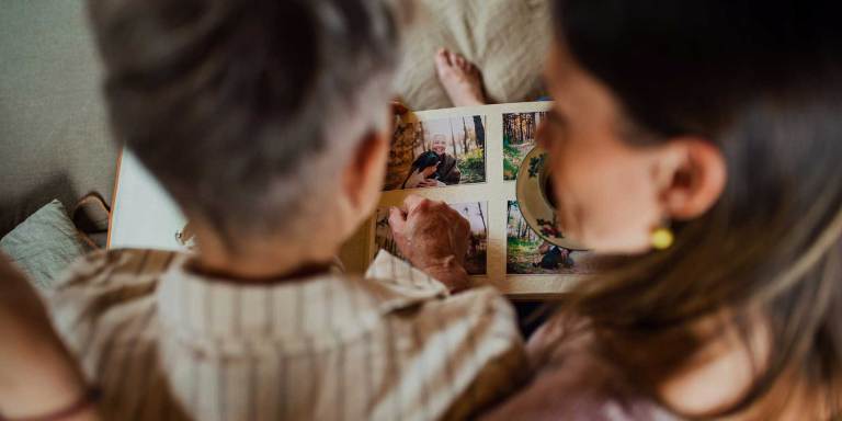 A mother and daughter looking at a photo album together