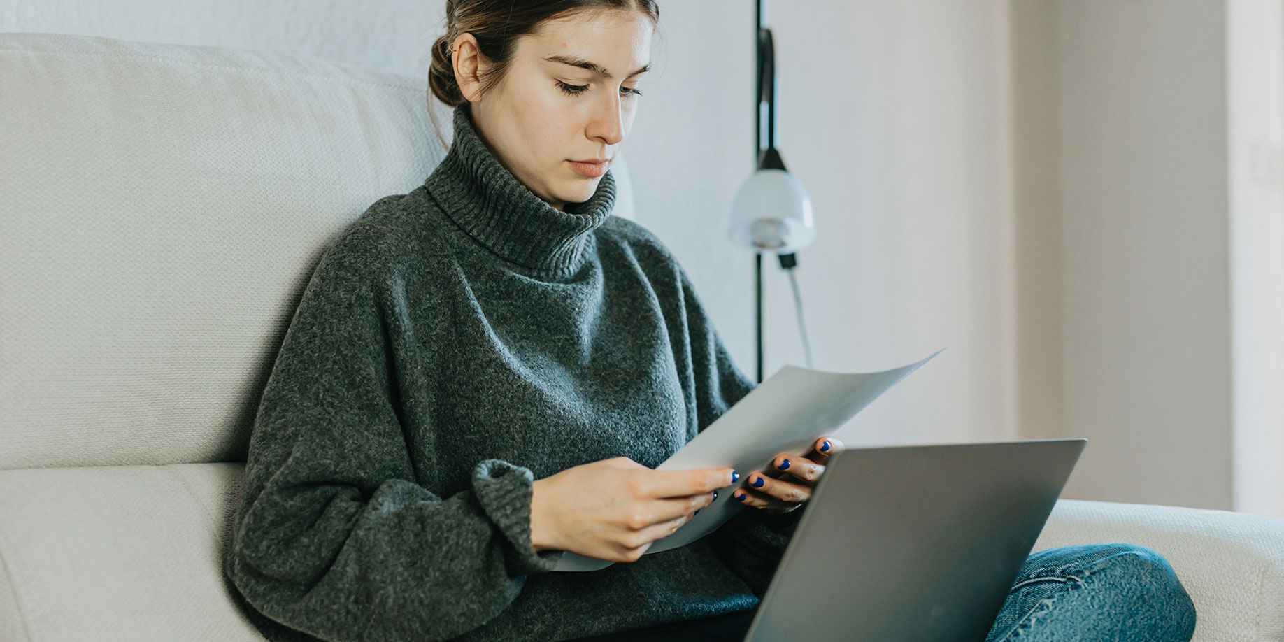A woman looking at her charitable donation receipts with her laptop