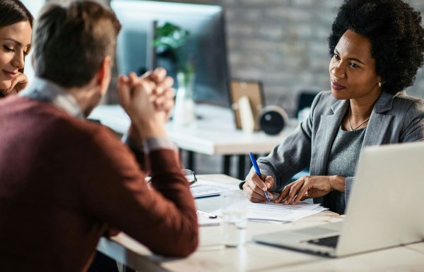 A couple speaking with a tax advisor